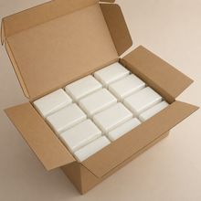 Open cardboard box filled with white foam blocks on a beige background