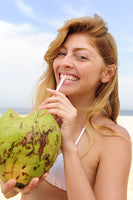 girl drinking a coconut